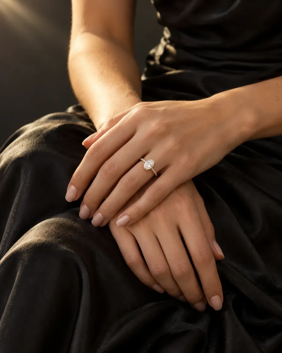 Hands wearing a fine diamond engagement ring